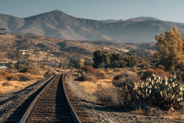 A railroad line running through a desert landscape—ideal for visualizing top vs bottom ballast differences in terrain.