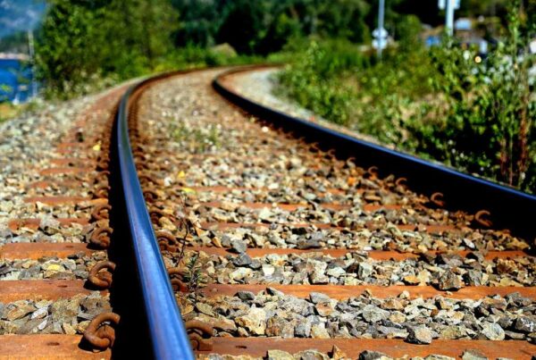 Angular crushed stone railroad ballast supporting railway tracks