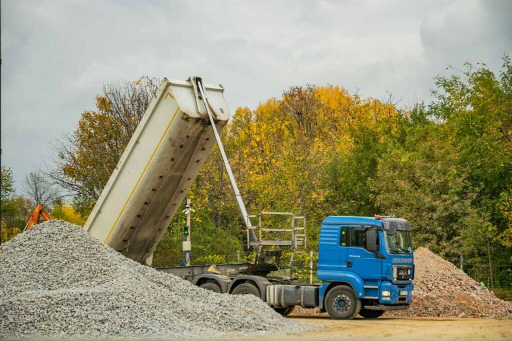 Dump truck unloading crushed rock for construction use